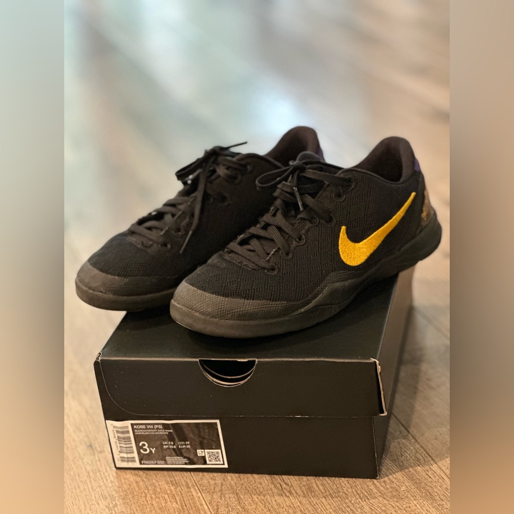 Nike Black and Gold Kobe sneakers